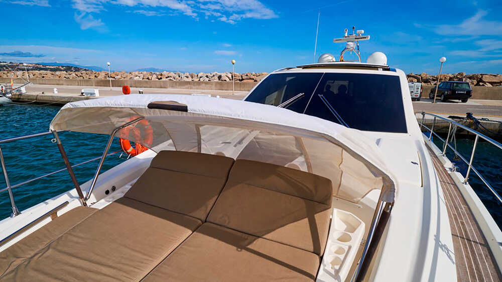 Sunbathing cushions on bow with Bimini top