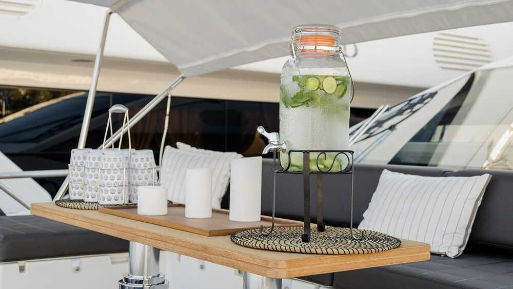 Seating area on bow with teak coffee table and Bimini top